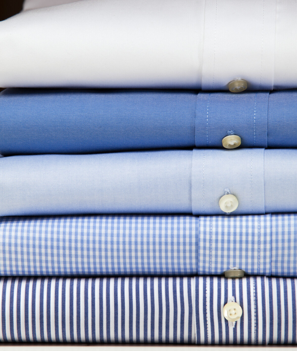 Freshly dry cleaned shirts on hangers at Delta Cleaners